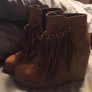 Brown fringe wedge booties.
